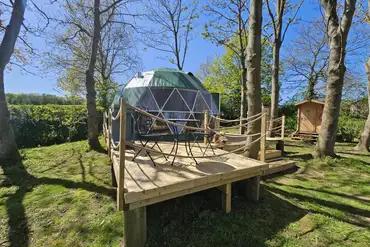 Geodome with a raised decking and outdoor seating