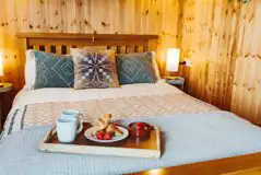 Caban Marta interior with a double bed with bedding Caban Marta interior with a double bed with bedding