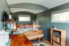 Caban Y Gors furnished interior with a king bed and bedding Caban Y Gors furnished interior with a king bed and bedding