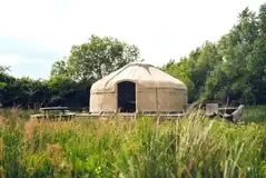 Elinir yurt set on a wooden decking with a table and chairs Elinir yurt set on a wooden decking with a table and chairs