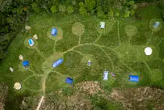 Aerial of the campsite with circular mown pitches Aerial of the campsite with circular mown pitches