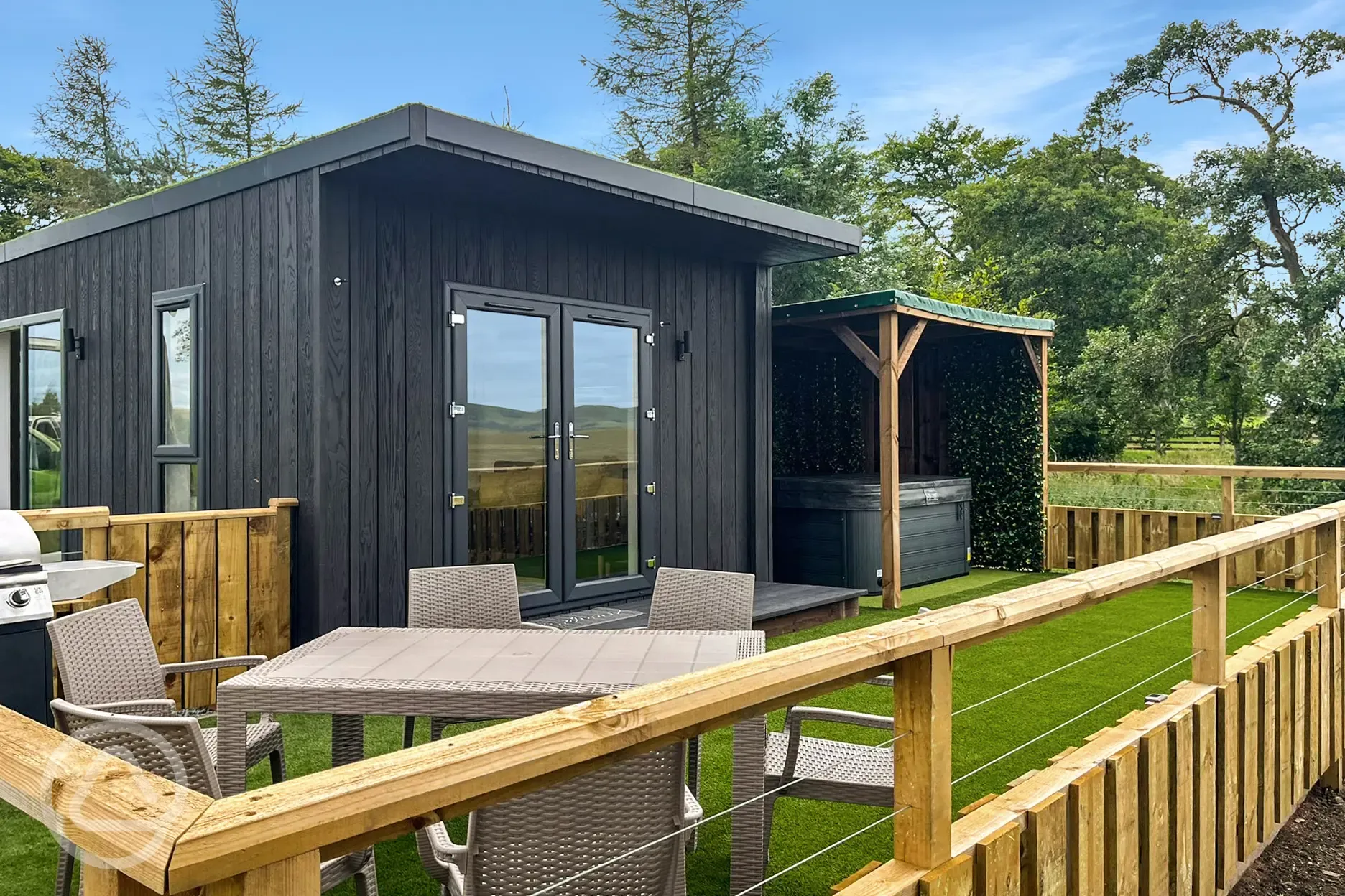 Glamping lodge outdoor area with hot tub