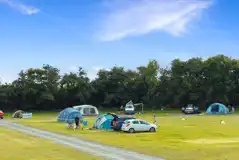 Grass pitches with space for a parked car
