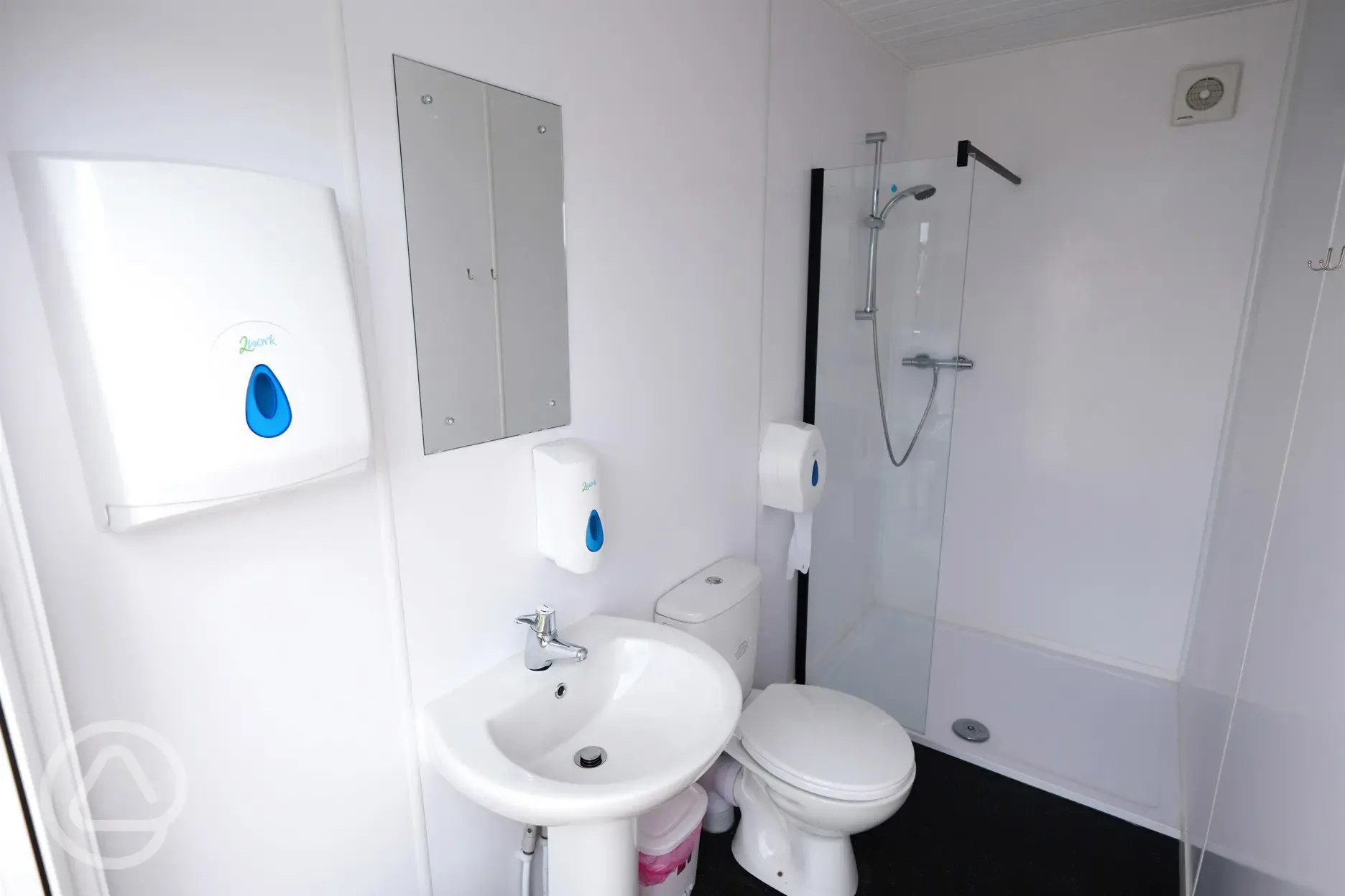 Bathroom interior with toilet, shower, heated towel rail, sink and mirror