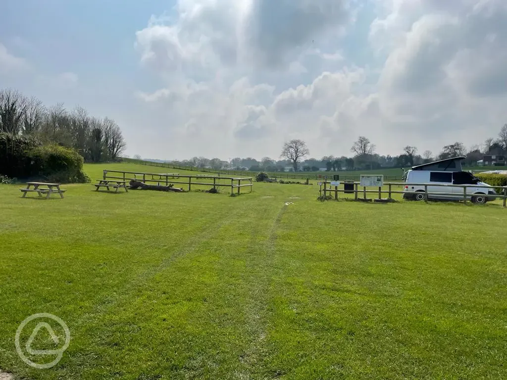 Electric grass pitches (main field) with picnic bench seating by the pub