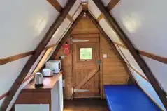 Apex glamping pod interior with microwave, toaster and kettle