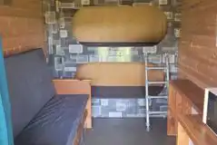 Bunk bed glamping pod interior with two bunk beds and two fold out beds