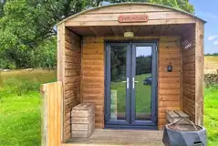 Bunkbed camping pod with a small deck area at Hensol Estate Holidays