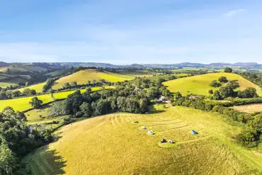 Aerial of Hincknowle Cider Apple Farm Camping in the Bridport countryside
