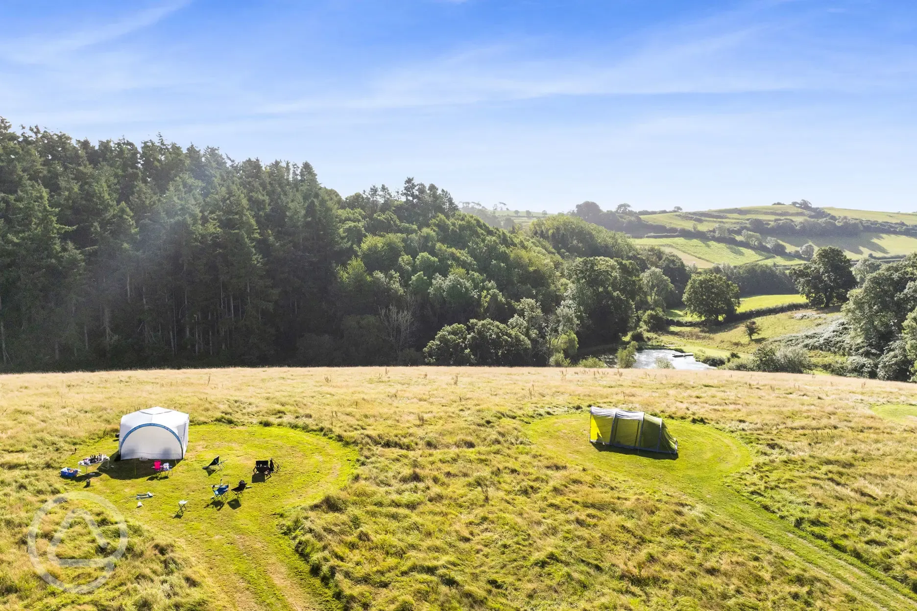 Aerial of the non electric grass pitches and onsite lake