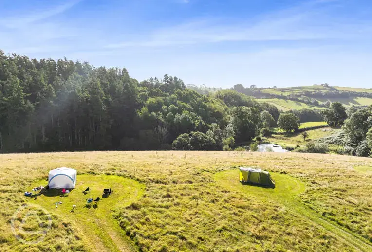 Aerial of the non electric grass pitches and onsite lake