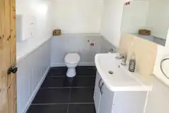 Toilet cubicle with a hand basin