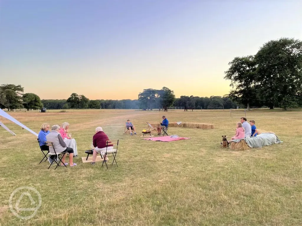 Campers around the communal fire pit