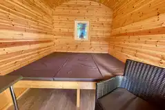 Carrock Fox shepherd's hut interior with a raised double mattress Carrock Fox shepherd's hut interior with a raised double mattress