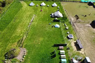 Aerial of the bell tent and alpacas