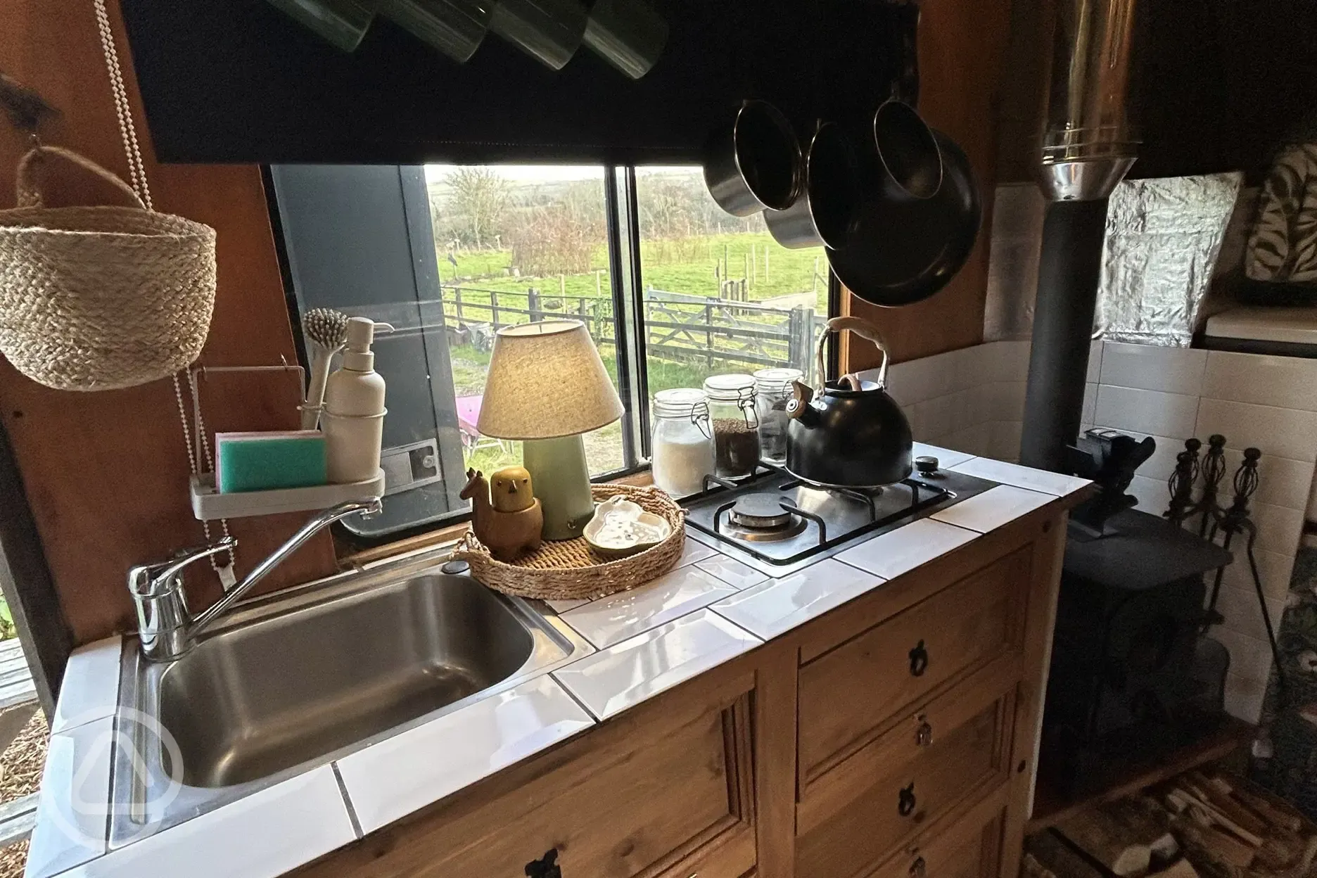 Converted horsebox kitchen area with a sink and hob