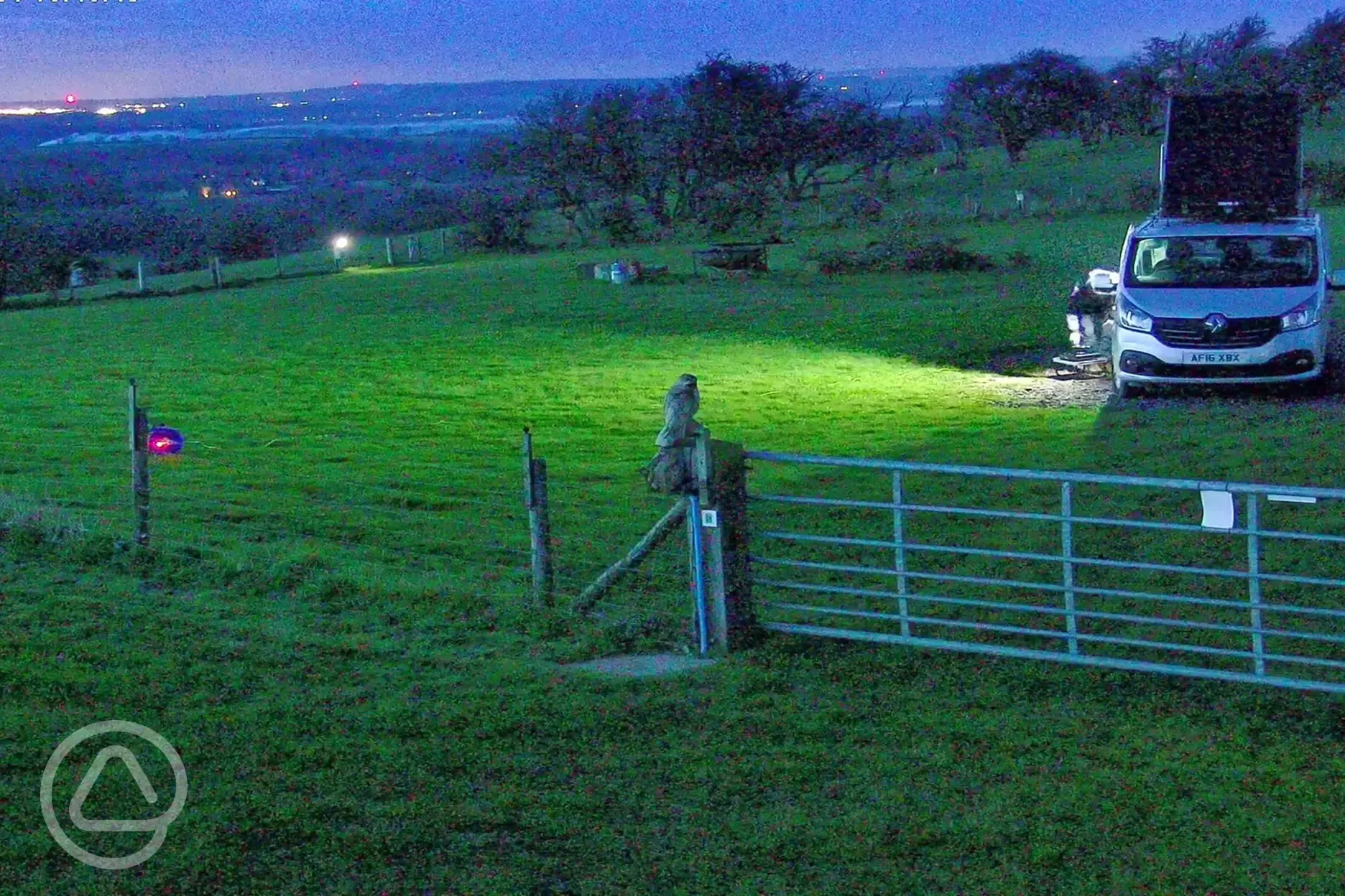 Campsite at night with view of Shrewsbury lights in the far distance