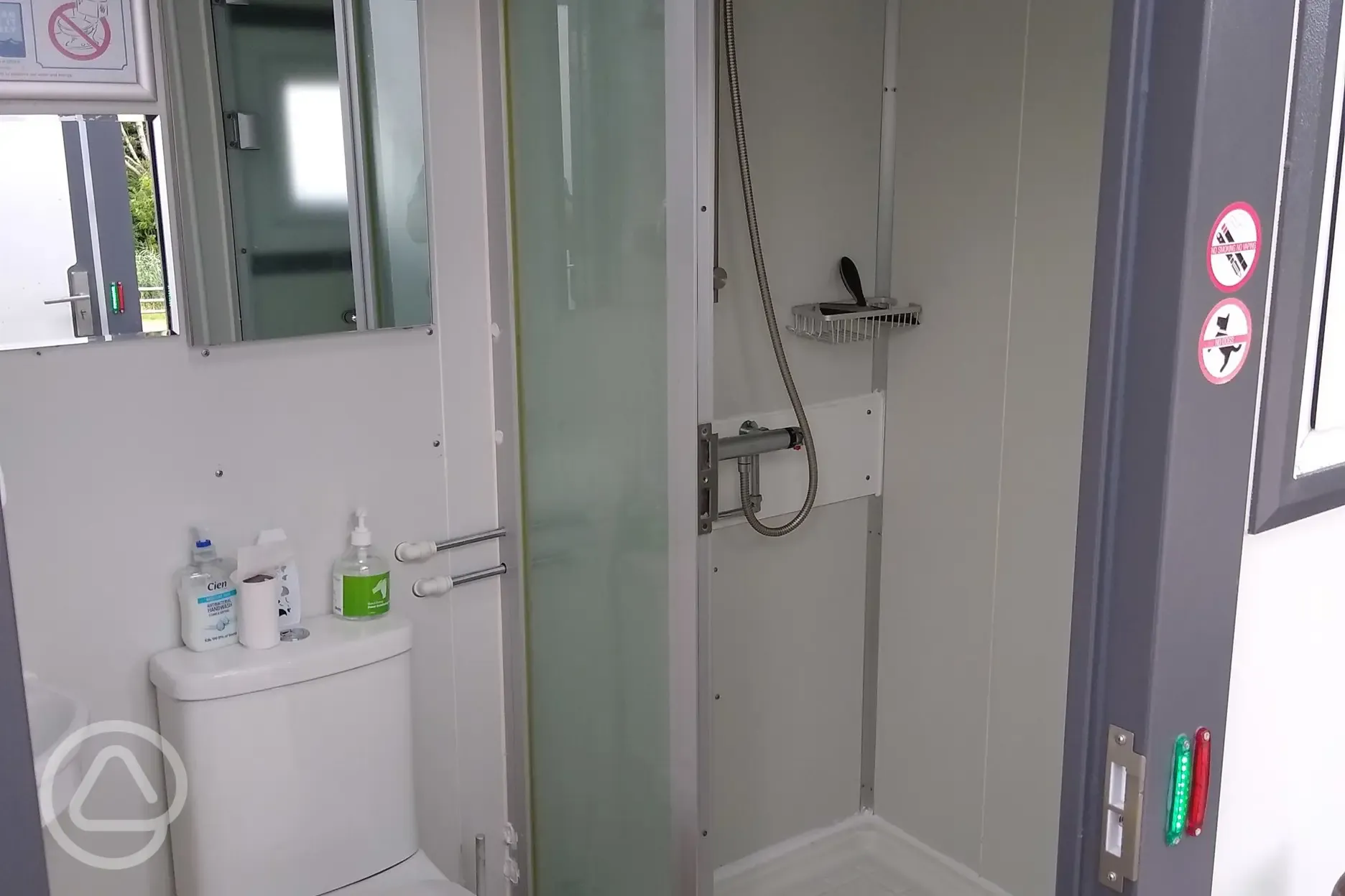 Toilet and free hot showers with shelves for toiletries Toilet and free hot showers with shelves for toiletries