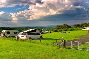 Small campervans on the main field with amazing views.