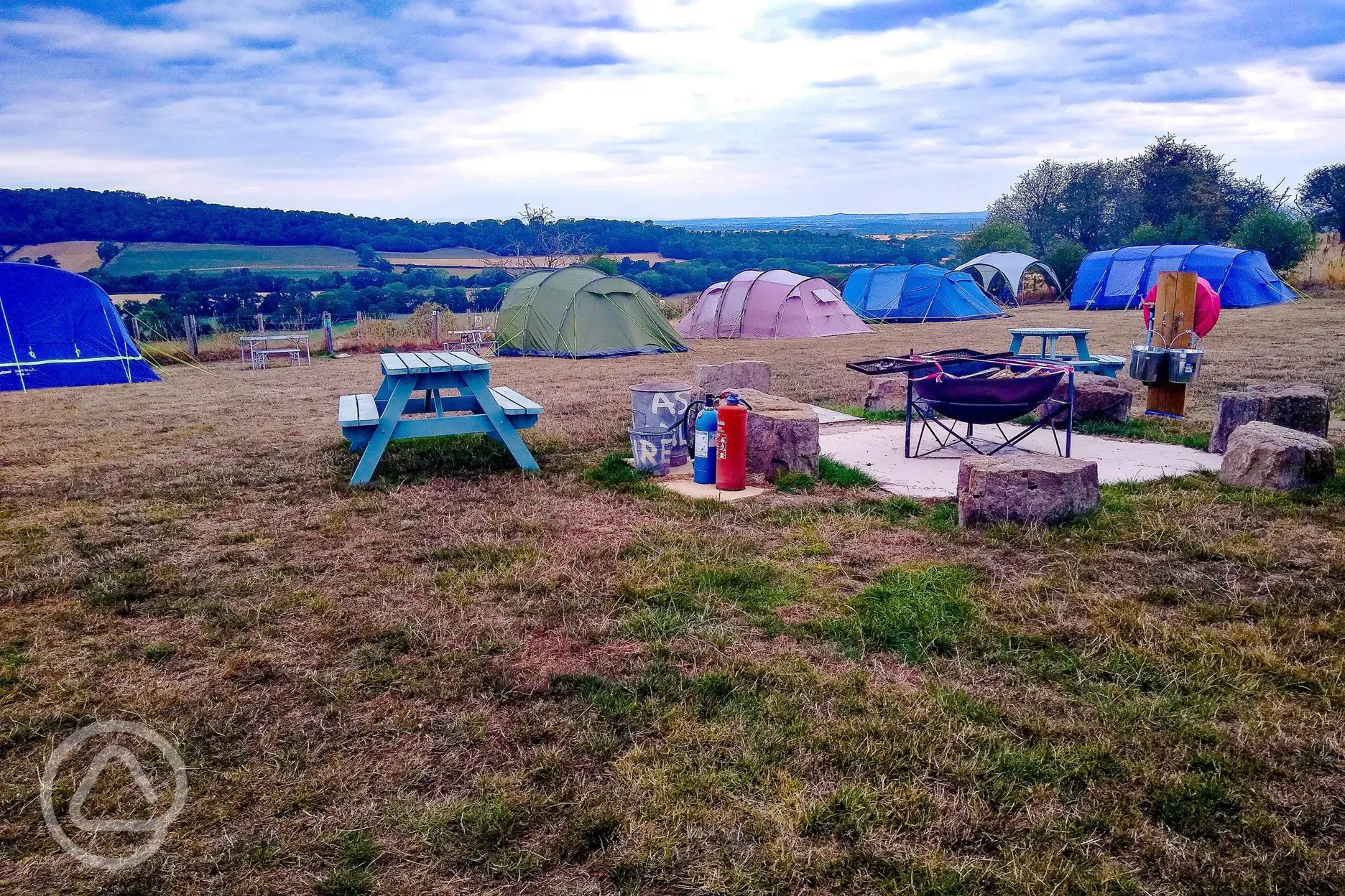 Tents on grass pitches (optional electric) by communal fire pit and picnic bench Tents on grass pitches (optional electric) by communal fire pit and picnic bench