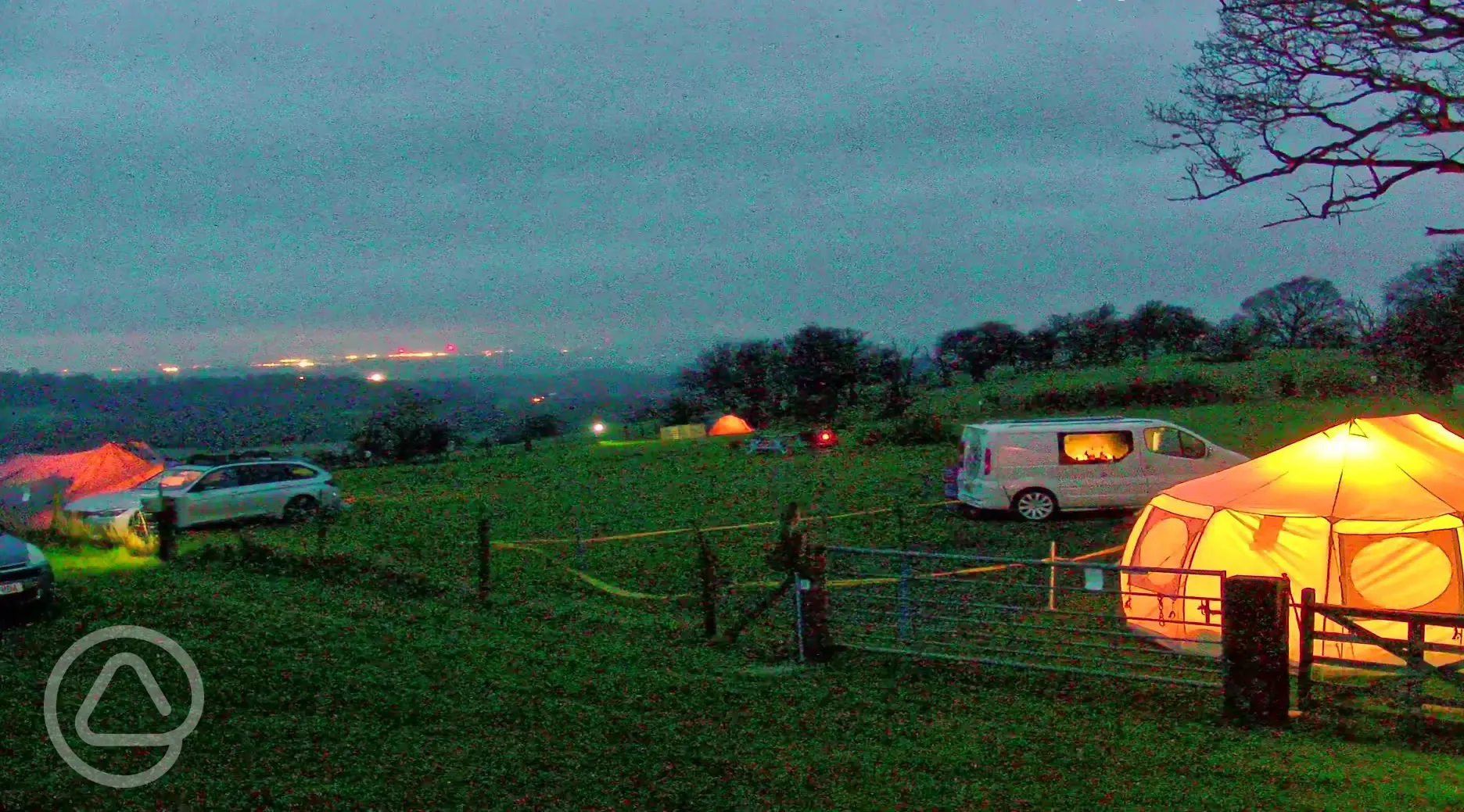 Campsite at dusk with distant lights of Shrewsbury