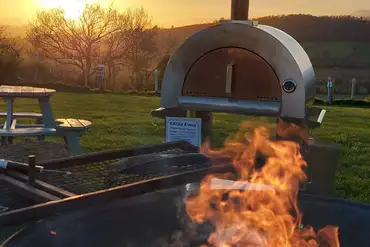Campfire and pizza oven situated on the top field