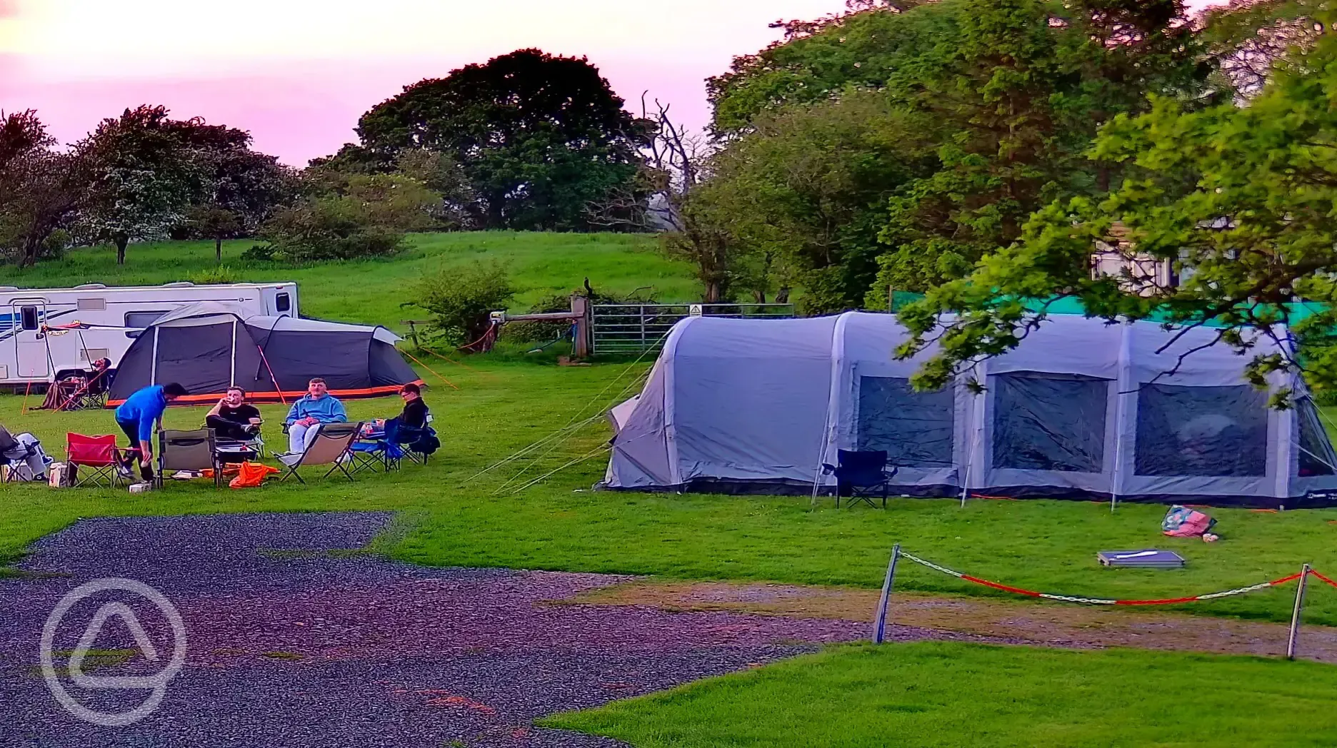 Maxi tent on large grass pitches at sunset (optional electric) Maxi tent on large grass pitches at sunset (optional electric)