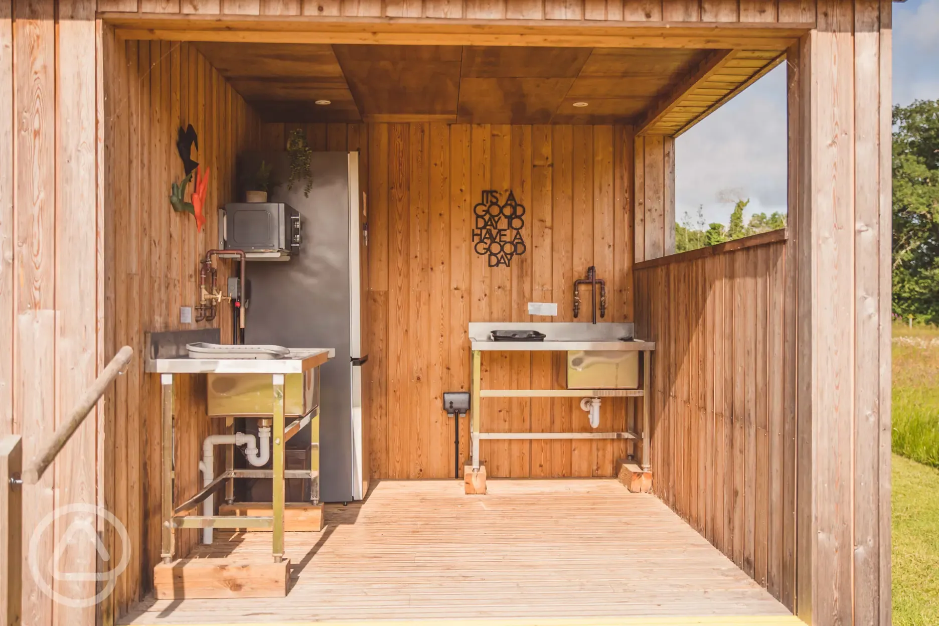 Washing up area with fridge freezer and microwave