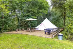 Hideaway bell tent exterior with outdoor seating Hideaway bell tent exterior with outdoor seating