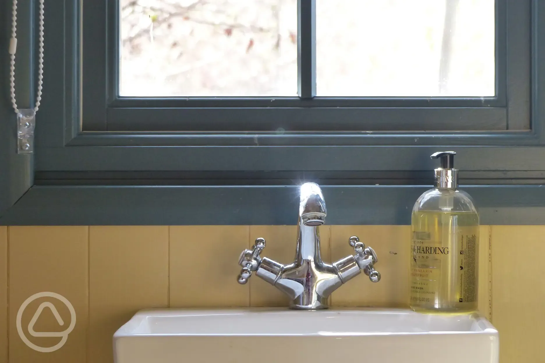 Oak shepherd's hut bathroom with hand soap