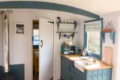 Oak shepherd's hut kitchen with a sink, fridge, microwave and kettle Oak shepherd's hut kitchen with a sink, fridge, microwave and kettle