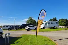 Hardstanding with grass touring pitches with optional 16 amp electric