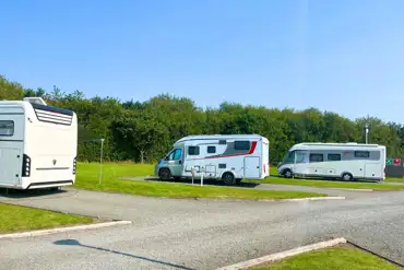 Hardstanding with grass touring pitches with optional 16 amp electric