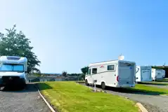 Hardstanding with grass touring pitches with optional 16 amp electric