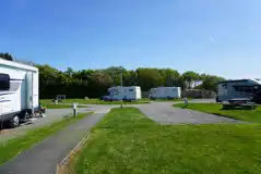 Hardstanding with grass touring pitches with optional 16 amp electric