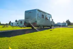 Hardstanding with grass touring pitches with optional 16 amp electric