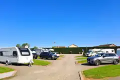 Hardstanding with grass touring pitches with optional 16 amp electric