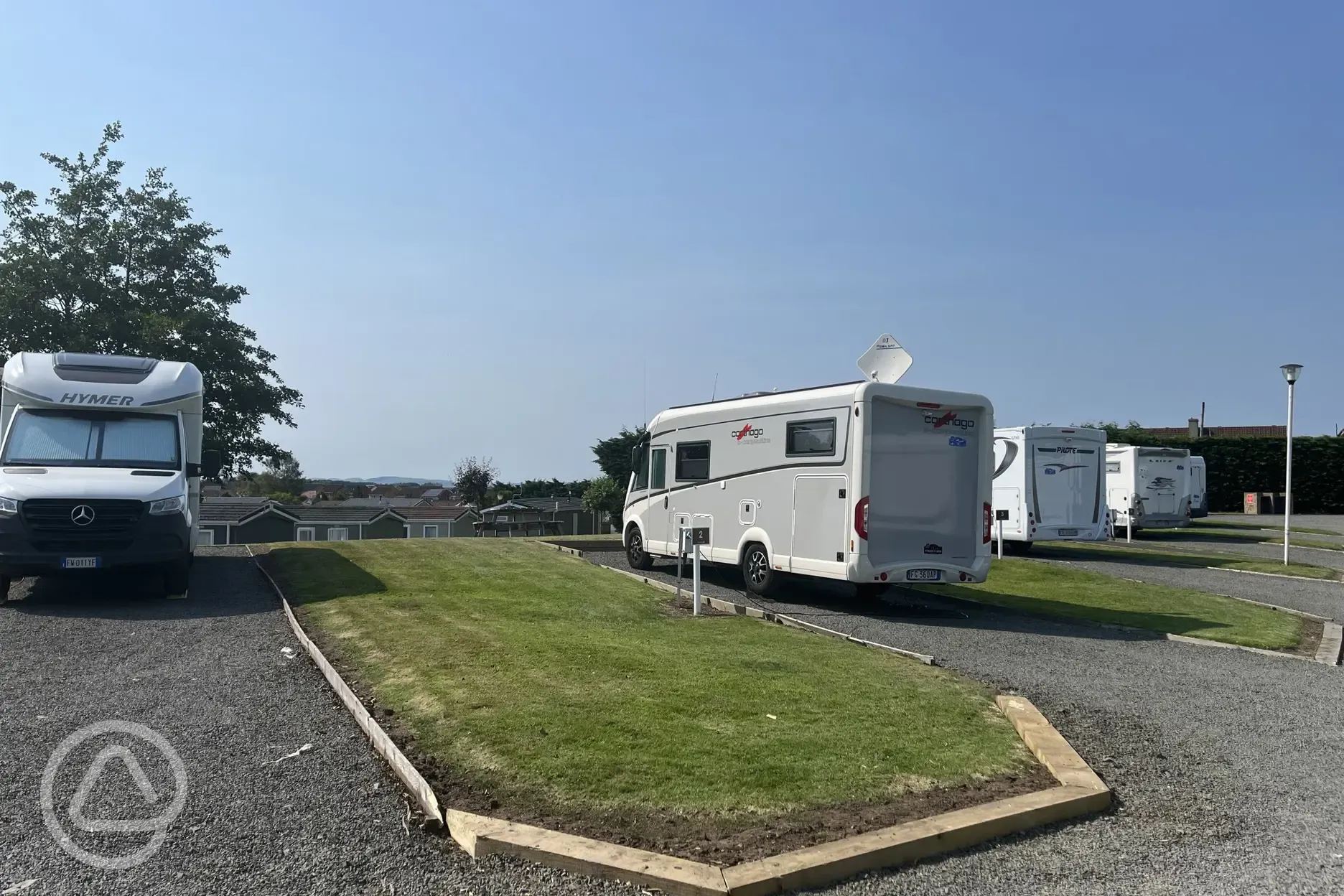 Hardstanding with grass pitches (optional electric)