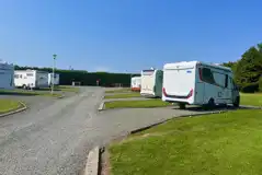 Hardstanding with grass touring pitches with optional 16 amp electric