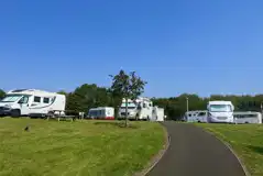 Hardstanding with grass touring pitches with optional 16 amp electric