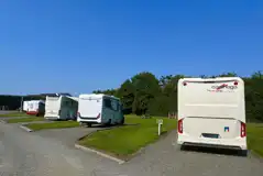 Hardstanding with grass touring pitches with optional 16 amp electric