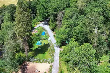 Aerial of Tree Tops and Train Tracks surrounded by woodlands