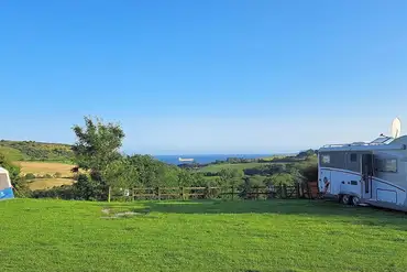 Grass and hardstanding pitches (optional electric) with sea views