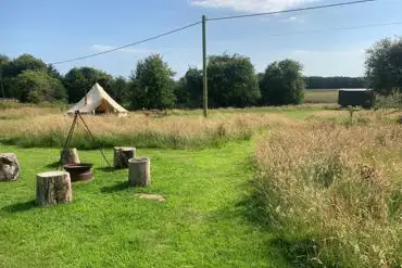 Bell tents with a fire pit at Sindles Farm