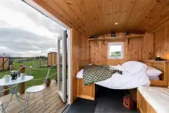 Railway wagon with a double bed (bedding included) and sofa bench
