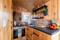 Railway wagon kitchen with a sink, fridge, oven and kettle