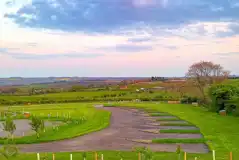 Electric hardstanding touring pitches at sunset Electric hardstanding touring pitches at sunset