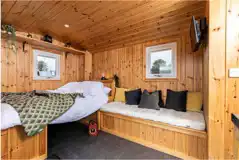 Railway wagon with a double bed (bedding included) and sofa bench