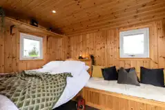 Railway wagon with a double bed (bedding included) and sofa bench