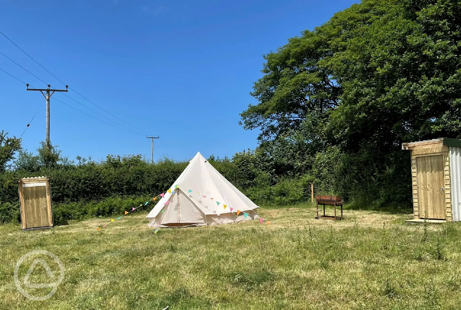 Outside of bell tent with private shower, and toilet units 
